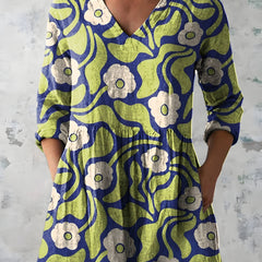 Green long blouse with V-neck worn with trousers