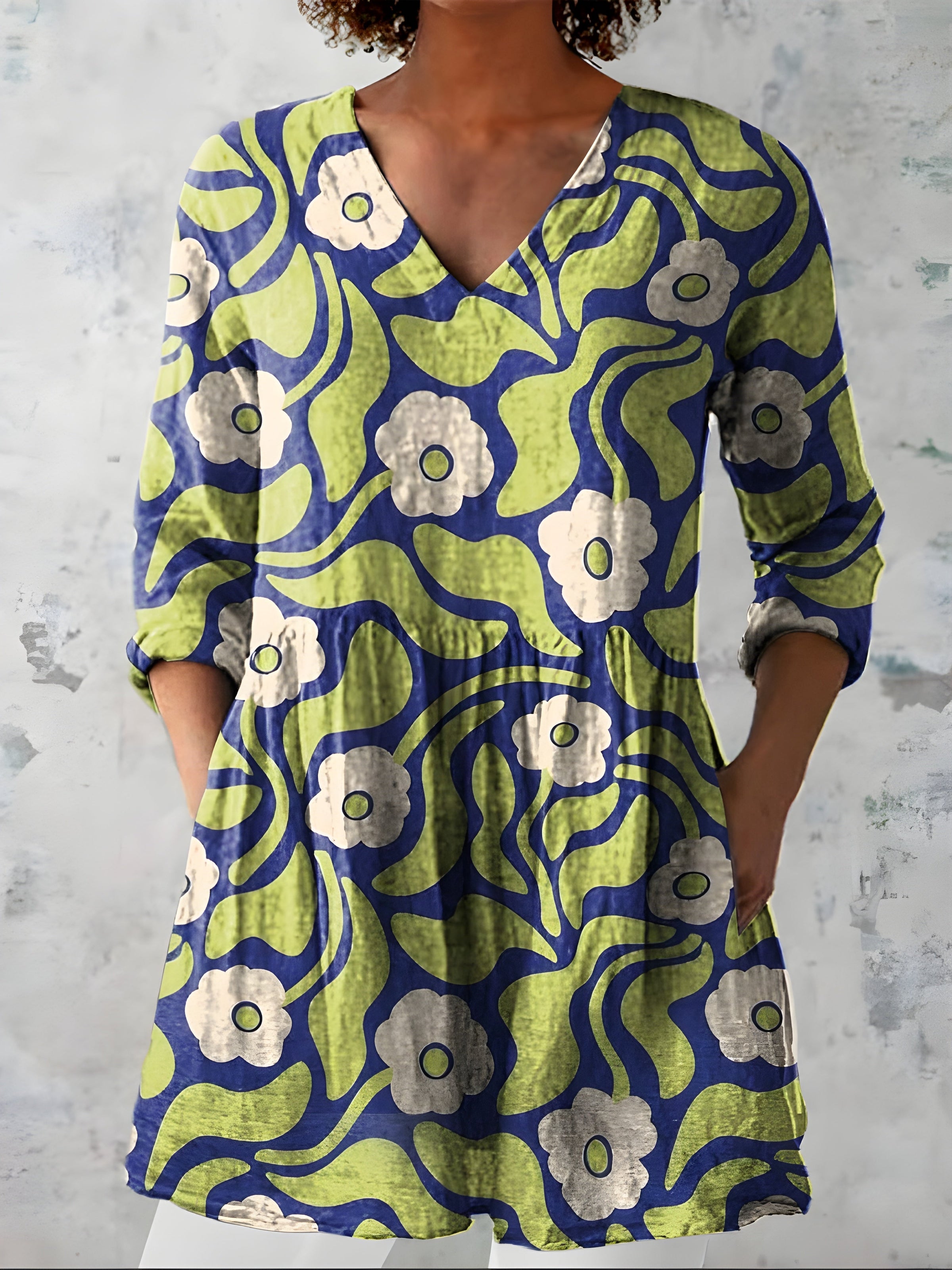 Green long blouse with V-neck worn with trousers