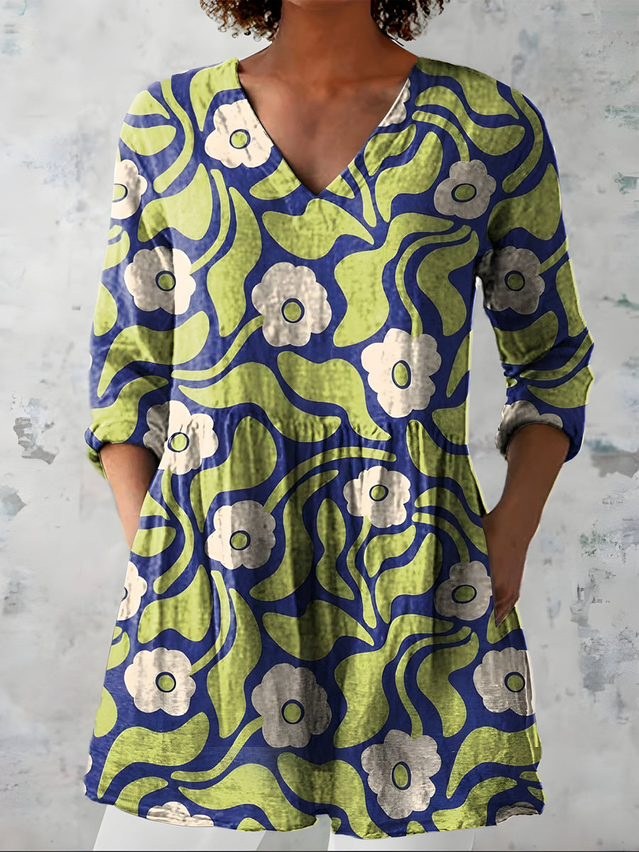 Green long blouse with V-neck worn with trousers