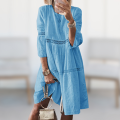 Tiered dress showing crew neck and three quarter sleeves