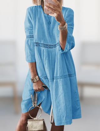 Tiered dress showing crew neck and three quarter sleeves