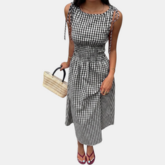 Woven midi dress laid flat showing the flared skirt