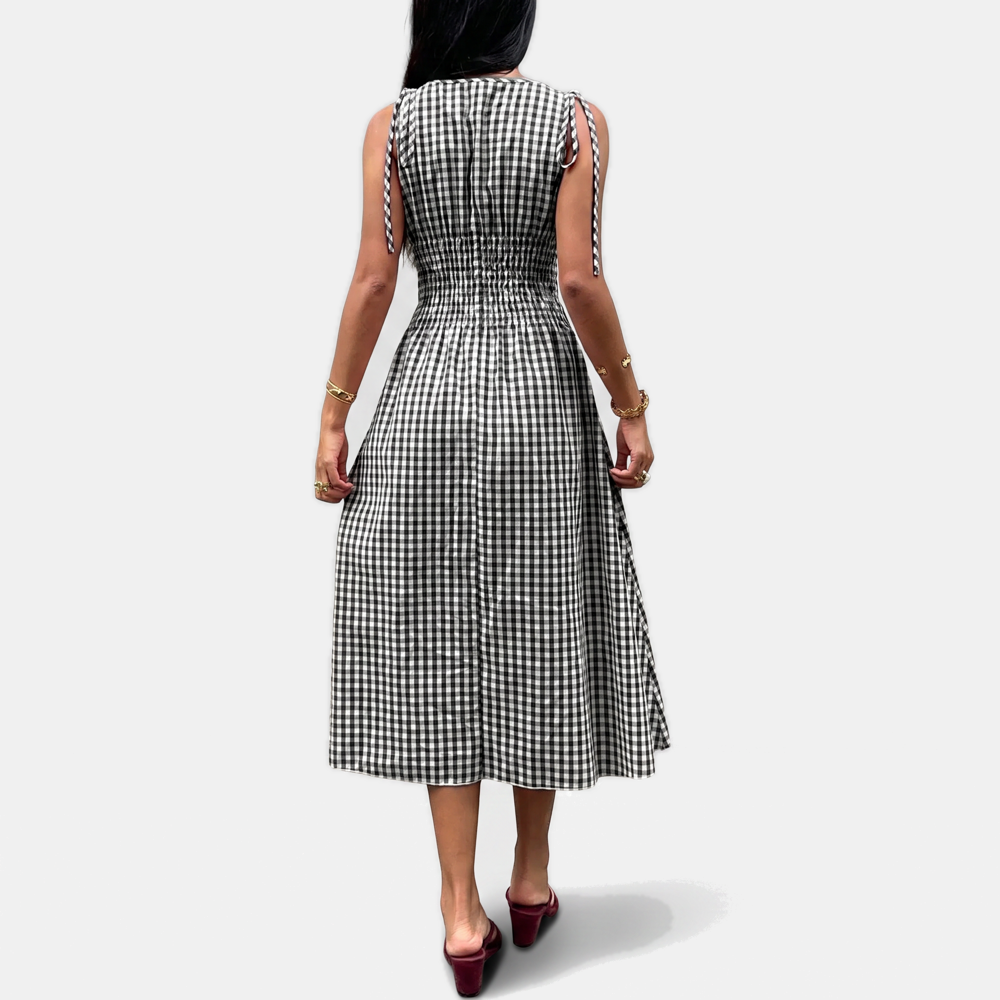 Flat view of the tie shoulder straps and smocked bodice