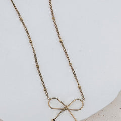 Ivy Dainty Bow Necklace in gold, bow charm detail