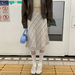 Check midi skirt styled with a knit top