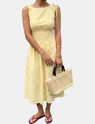 Yellow smocked waist midi dress laid flat